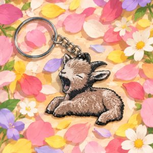 Llavero plano de Pétalo, cabrita bostezando, entre pétalos de flores